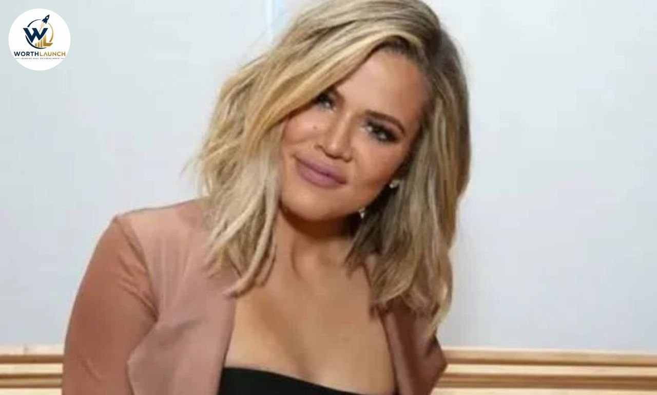 Jan Ashley smiling at the camera while wearing a black top and blush-pink blazer.