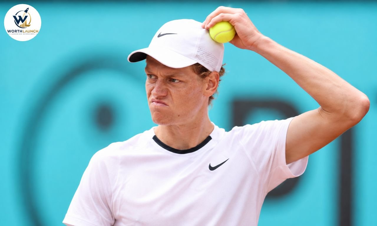 Jannik Sinner holding a tennis ball during a professional tennis match.