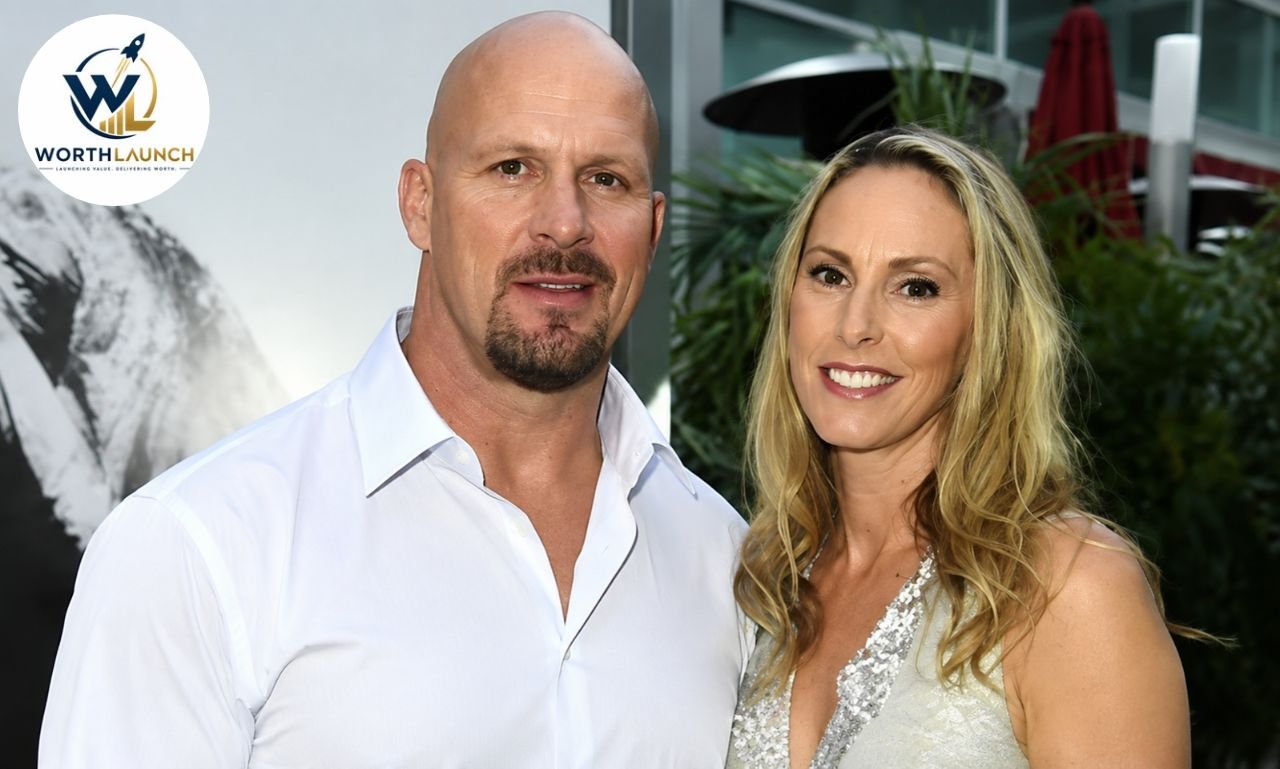 A couple posing together at a formal event, smiling at the camera.