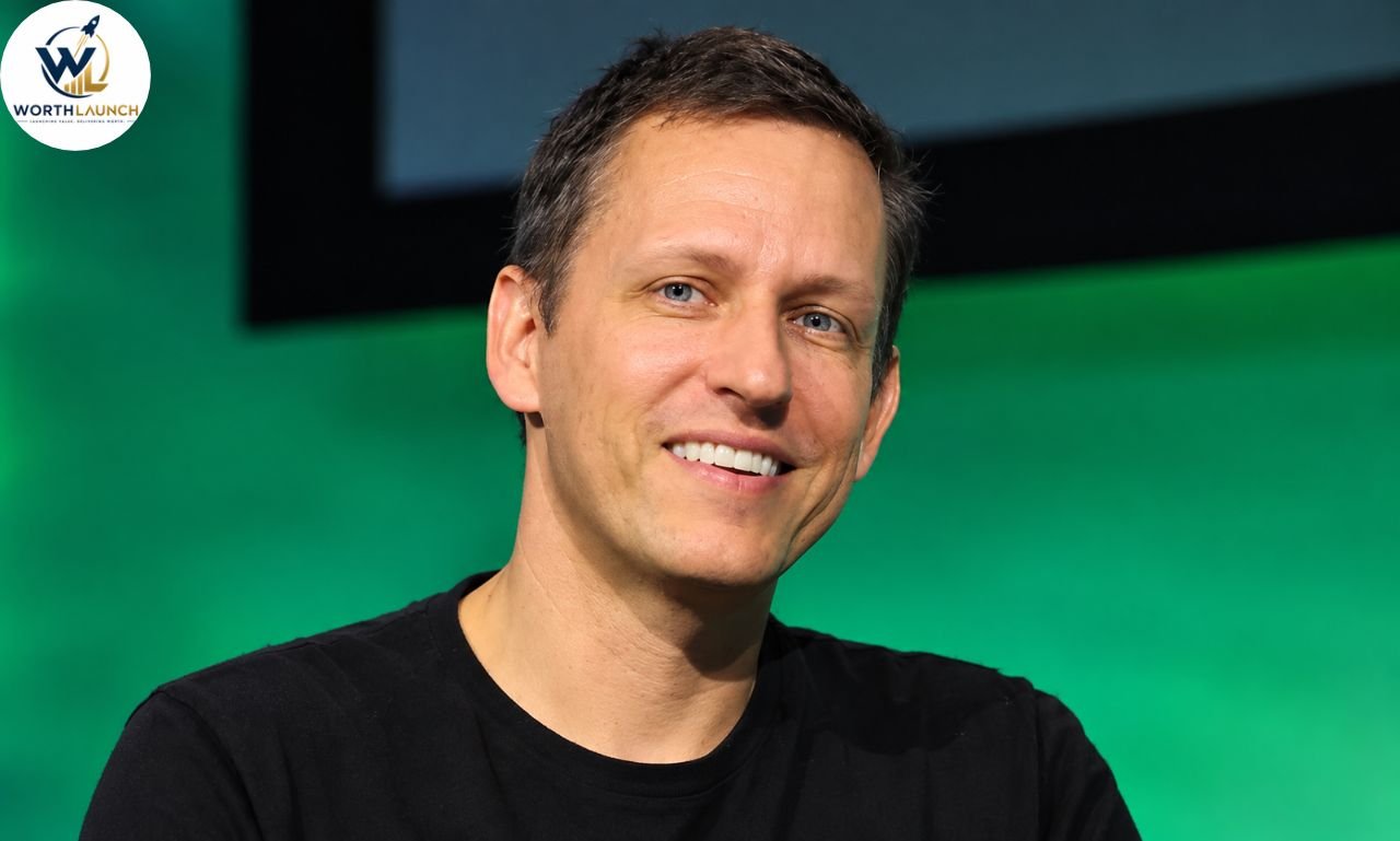 Smiling man in a black shirt posing against a green and dark modern background.