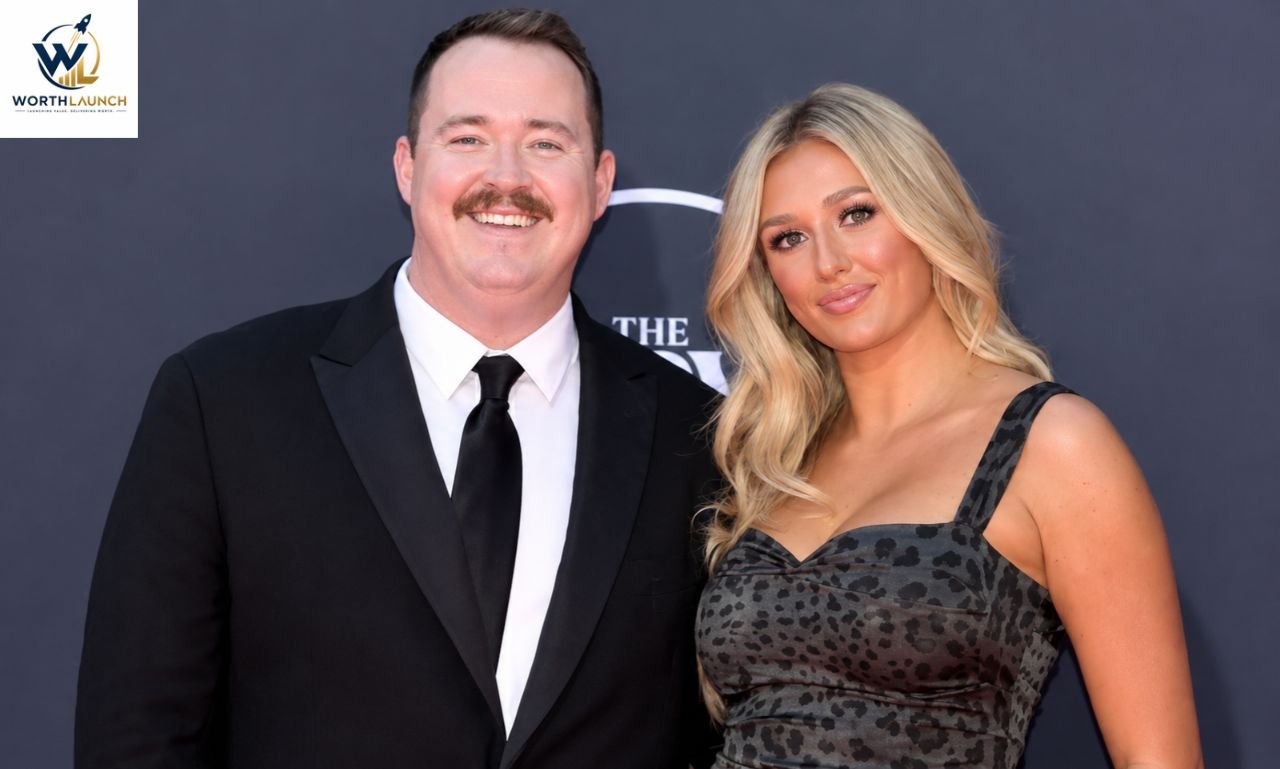 Man and woman posing together at a red-carpet event in formal attire.