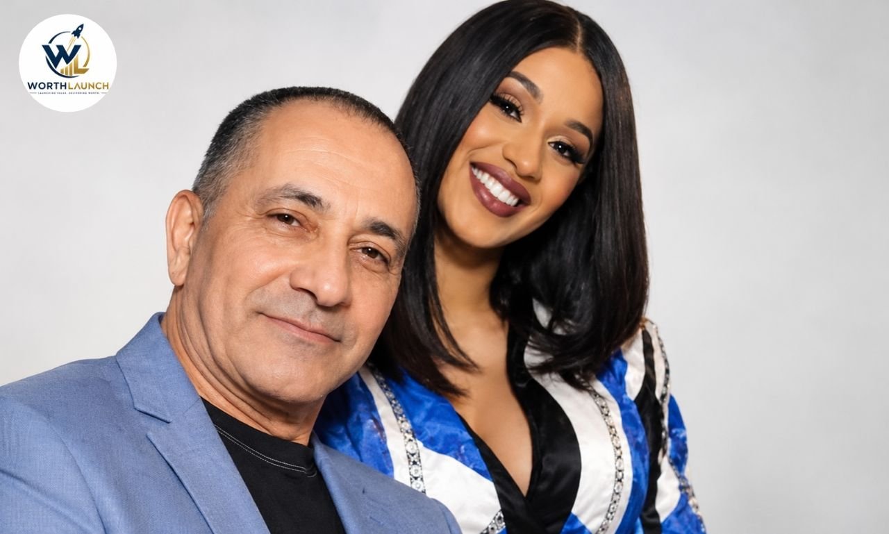 Carlos Alman posing with Cardi B in a blue outfit against a clean studio background.