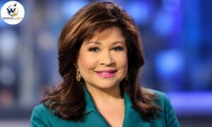 Clarice Tinsley portrait wearing a teal blazer with elegant gold earrings against a blue studio background.