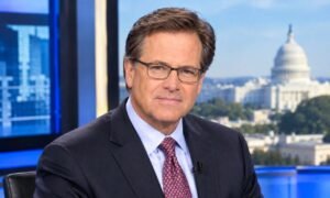 David Asman in a professional news studio wearing a suit and tie with the U.S. Capitol building visible in the background.