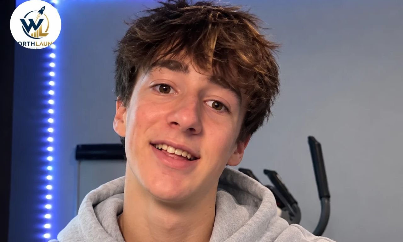 Paultooreall smiling in a gray hoodie during a casual indoor selfie.